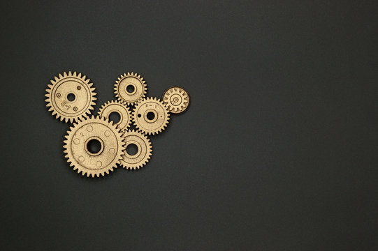 plastic golden gears on gray background