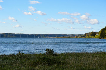 Vejle fjord with bridge and blue sky with clouds - 325432097