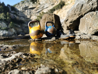 Two Kettlebells With Lifting Shoes and Reflection