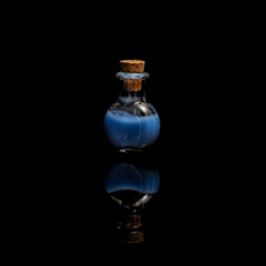 Glass test tubes with blue liquid isolated on black background.