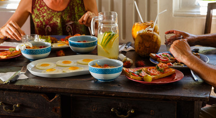 hands of a woman and a man on the table at Breakfast healthy food close-up. Concept of healthy eating in the open air