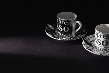 Two cups of coffee on the black table