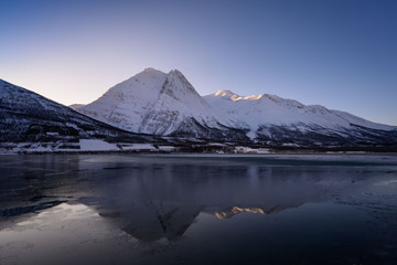 Fototapeta na wymiar Winter Fugltinden mountain with reflection in Northern Norway