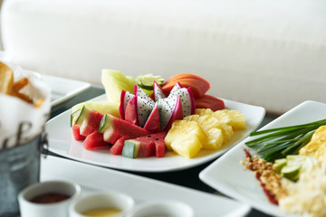 dragon fruit,pine apple,melon,water melon,papaya in plate for snack dessert mixed fruit serve
