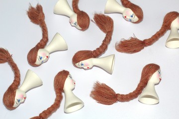 White porcelain heads with a painted face for making dolls. Folk crafts.