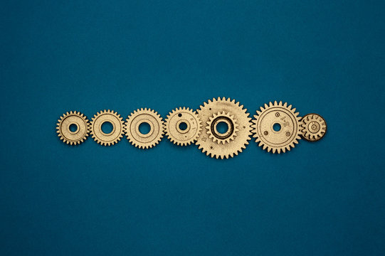template of seven golden gears on blue background