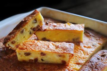 Ceramic bowl with baked curd casserole, close-up. Homemade cakes.