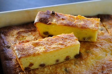 Baked homemade cottage cheese casserole with raisins. Close-up.
