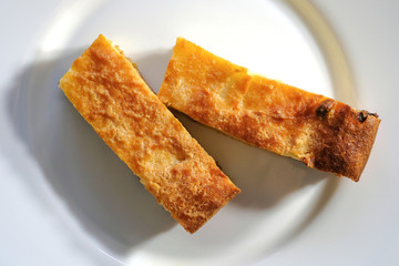 Two pieces of cottage cheese casserole on a plate. Top view.