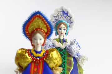 Fototapeta na wymiar Two dolls in national Russian clothes. Sundress, kokoshnik. Light background.