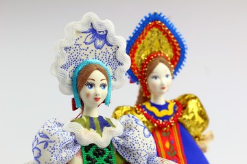 Two dolls in national Russian clothes. Sundress, kokoshnik. Light background.