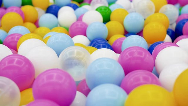 4k dolly video of pool full of colorful plastic balls on children playground