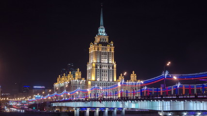 Fototapeta na wymiar Hotel Ukraine winter night timelapse with bridge over Moscow River.