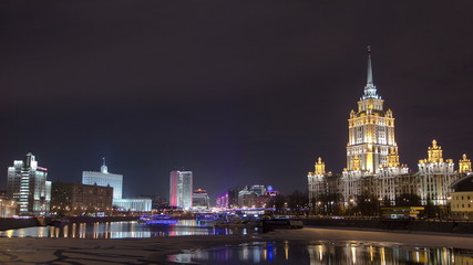 Fototapeta na wymiar Hotel Ukraine winter night timelapse. Seen as reflected in the Moscow River.