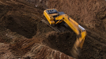 Yellow excavator on a construction site timelapse