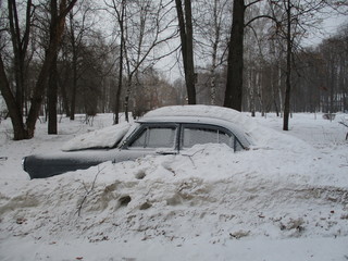 Vintage Russian car almost covered with snow in the month of February
