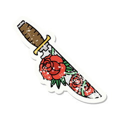 traditional distressed sticker tattoo of a dagger and flowers