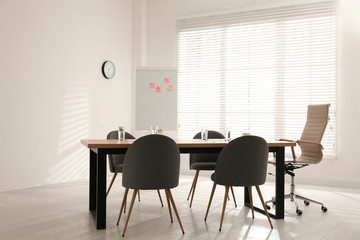 Simple office interior with large table and chairs