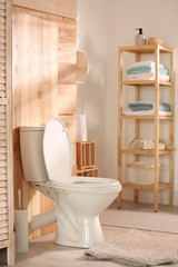 Modern toilet bowl in stylish bathroom interior