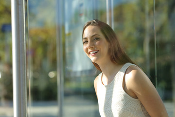 Woman waiting for trasport to come at bus stop