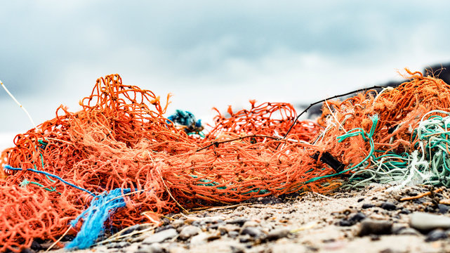 Fishing nets from industrial fishing on the beach as waste
