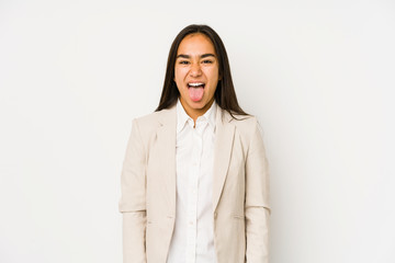 Young woman isolated on a white background funny and friendly sticking out tongue.