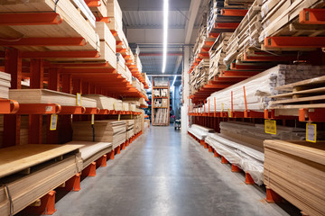 Hardware store. Shop of building materials. Racks with boards, wood and building material. loaded...