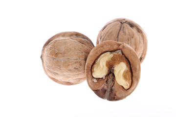 Whole and cracked walnuts isolated on white background