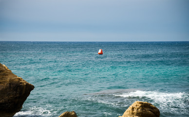 Obraz premium Orange buoy in the Mediterrean sea in Spain