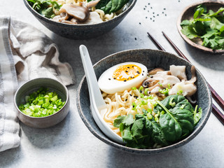Vegetarian Miso Ramen with Mushrooms, raw Spinach and boiled Egg in blue bowl