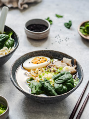 Vegetarian Miso Ramen with Mushrooms, raw Spinach and boiled Egg in blue bowl