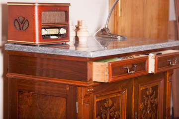 antiques, beautiful old dresser with door ornaments and radio