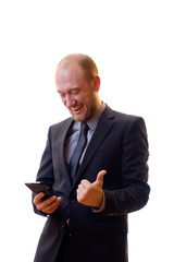 Businessman in a black suit, shirt and tie using a mobile phone in order to keep abreast of all the...