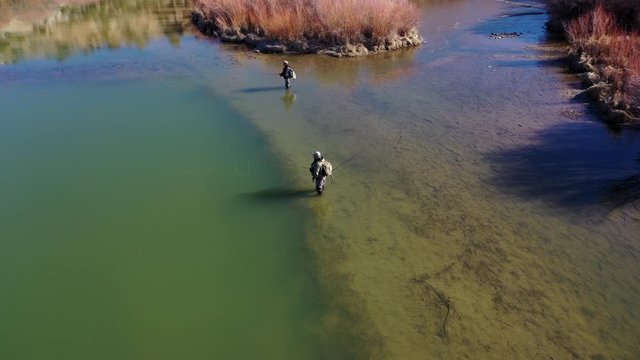aerial 4k high resolution of a man fly fishing the San Jaun river in New Mexico.