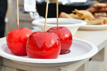 Red caramelized apples on stick