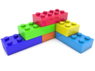 Toy bricks of different colors connected one above the other