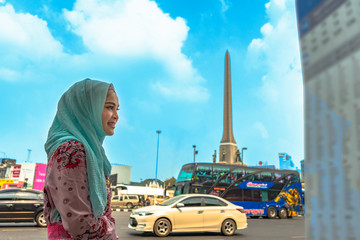 Islam lady waiting for a bus at bus stop at vctory monument.