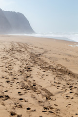 Ocean coast, moviment waves with foam. Wind power. Turquoise water.