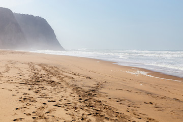 Ocean coast, moviment waves with foam. Wind power. Turquoise water.
