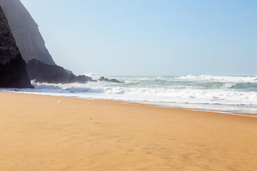 Ocean coast, moviment waves with foam. Wind power. Turquoise water.