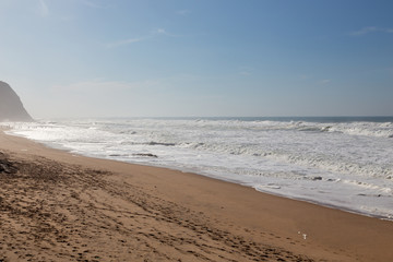Ocean coast, moviment waves with foam. Wind power. Turquoise water.