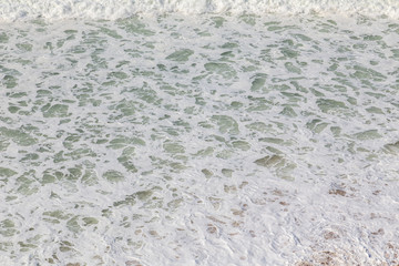 Ocean coast, moviment waves with foam. Wind power. Turquoise water.