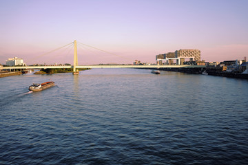 Obraz premium River Rhine and modern architecture in Cologne, North Rhine-Westphalia, Germany. Crane houses and bridge in the Rheinauhafen of Cologne.