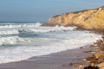 Fototapeta na wymiar Ocean coast, moviment waves with foam. Wind power. Turquoise water.