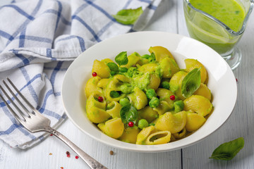 Italian pasta with green peas and basil.