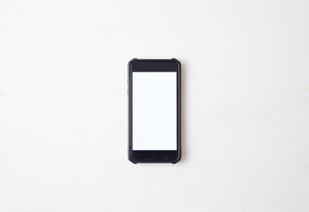 White office desk table with smartphone.