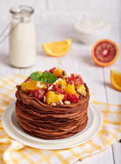 Sweet chocolate pancakes with oranges and chocolate. Thin crepes. Traditional Russian cuisine. Crepe week. Maslenitsa.