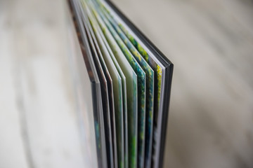 Side view close up of thick and rigid wedding album pages in a book