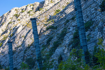 Metal barricade for falling stones from the hill. 
