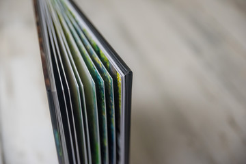 Side view close up of thick and rigid wedding album pages in a book